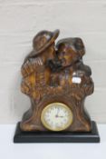 An antique carved West German black forest style figural mantel clock