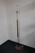 A mid 20th century teak and brass standard lamp