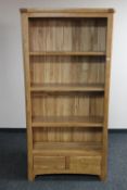 A set of contemporary oak open bookshelves