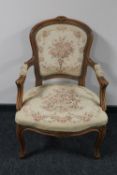 A beech framed armchair in floral fabric
