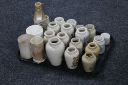 A tray containing approximately twenty-one cream ware bottles and kitchen jars,