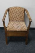 A mid 20th century commode armchair
