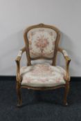 A beech framed armchair in floral fabric