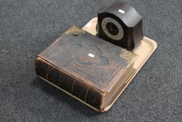 A leather bound family bible with colour lithographic book plates and a Bakelite mantel clock