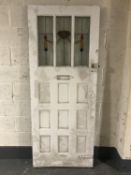 An early 20th century exterior door with stained leaded glass panels