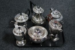 A tray of six silver plated tea and coffee pots