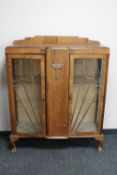 A 1930's walnut double door display cabinet