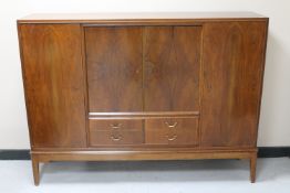 A mid 20th century walnut four door sideboard