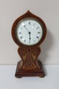 An early 20th century inlaid mahogany balloon shaped mantel clock