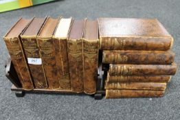 An oak Art Deco book trough together with twelve volumes of British Encyclopaedia