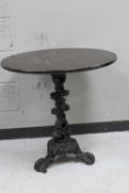 A cast iron bar table with oak top