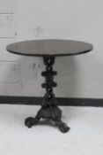 A cast iron bar table with oak top