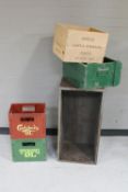 Three painted wooden crates and two plastic crates 
