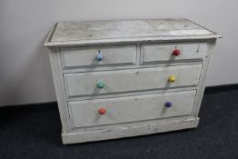 An antique painted pine four drawer chest