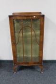 A 1930's walnut single door display cabinet