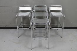 A set of four metal bar stools