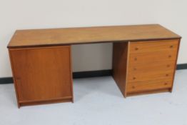 A mid 20th century Danish teak dressing table fitted with a cupboard and five drawers