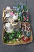 Two boxes containing coloured glass bottles, hurricane lamps, mini trellises,