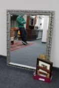 A contemporary silvered framed bevelled overmantel mirror together with a box containing two framed