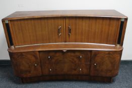 A mid 20th century shaped walnut sideboard