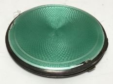 An Art Deco silver and green enamel circular powder compact, Birmingham 1932.