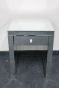 A contemporary mirrored lamp table fitted a drawer