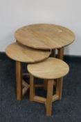 A nest of three circular contemporary oak stools