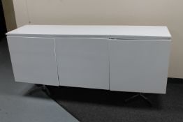 A white high gloss three door sideboard on metal legs