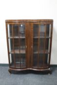 A shaped mahogany double door display cabinet