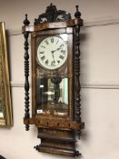 A Victorian rosewood and parquetry inlaid wall clock with enamelled dial, 41 cm.