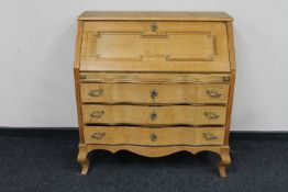 A blonde oak writing bureau