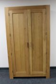 A contemporary oak double door wardrobe
