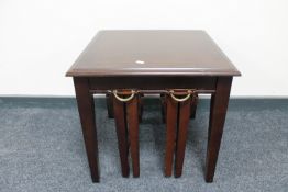 A mahogany lamp table fitted two tables beneath