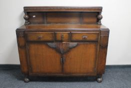 A 1930's carved oak buffet back sideboard