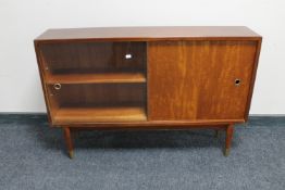 A mid 20th century teak sliding door bookcase