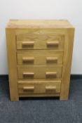 A contemporary oak four drawer chest