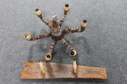 A carved pine six branch chandelier together with a deer's hoof gun rack
