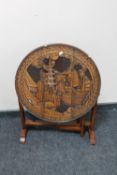 A carved oriental folding table
