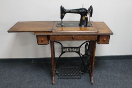 A Singer treadle sewing machine in oak table