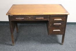 An early 20th century oak single pedestal desk with slide