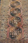 A fringed Persian runner of geometric design,