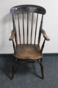 An antique elm kitchen armchair