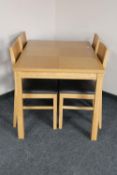 A contemporary oak effect dining table and four chairs