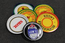 Ten assorted metal pub trays bearing advertising