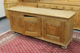 A blond oak triple door sideboard