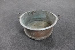 An antique copper twin handed cooking pot