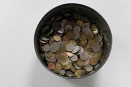 A biscuit tin of foreign coins