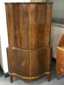 A mid twentieth century walnut double door corner cabinet