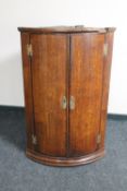 A George III oak hanging corner cabinet