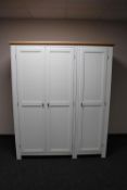 A contemporary white triple door wardrobe
